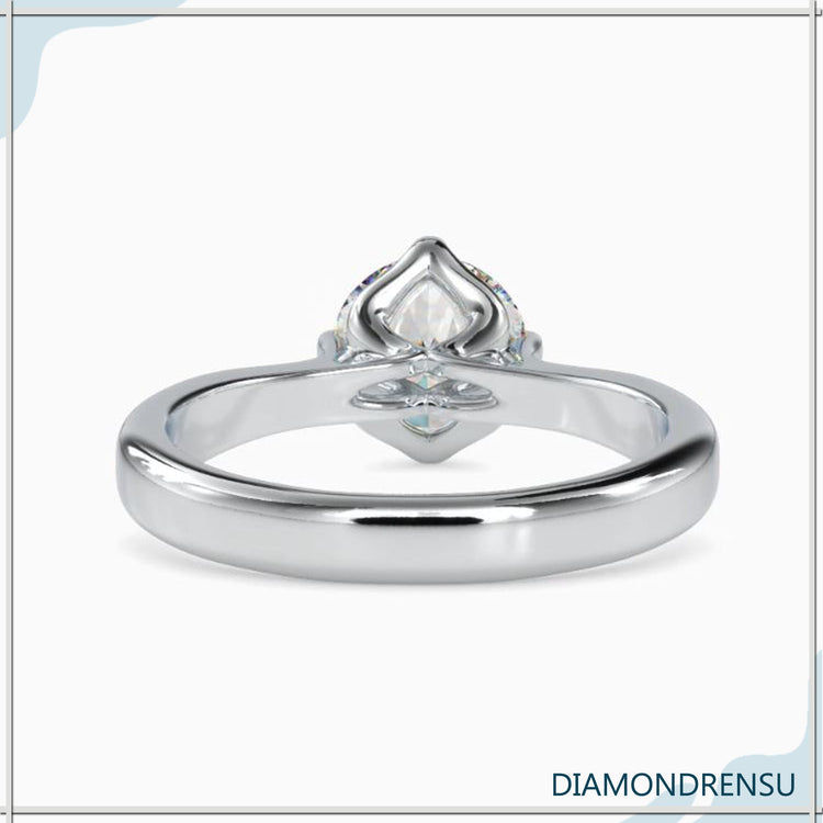 UK engagement ring in white gold with round diamond setting.
