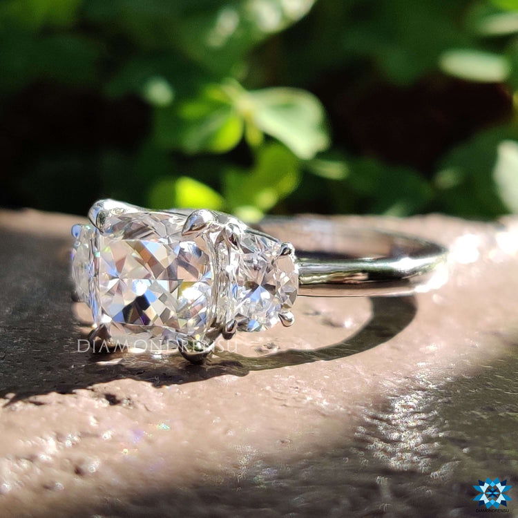 Custom cushion cut moissanite ring with claw prong setting.
