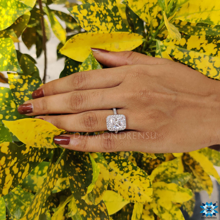 White gold ring with moissanite and pavé band.
