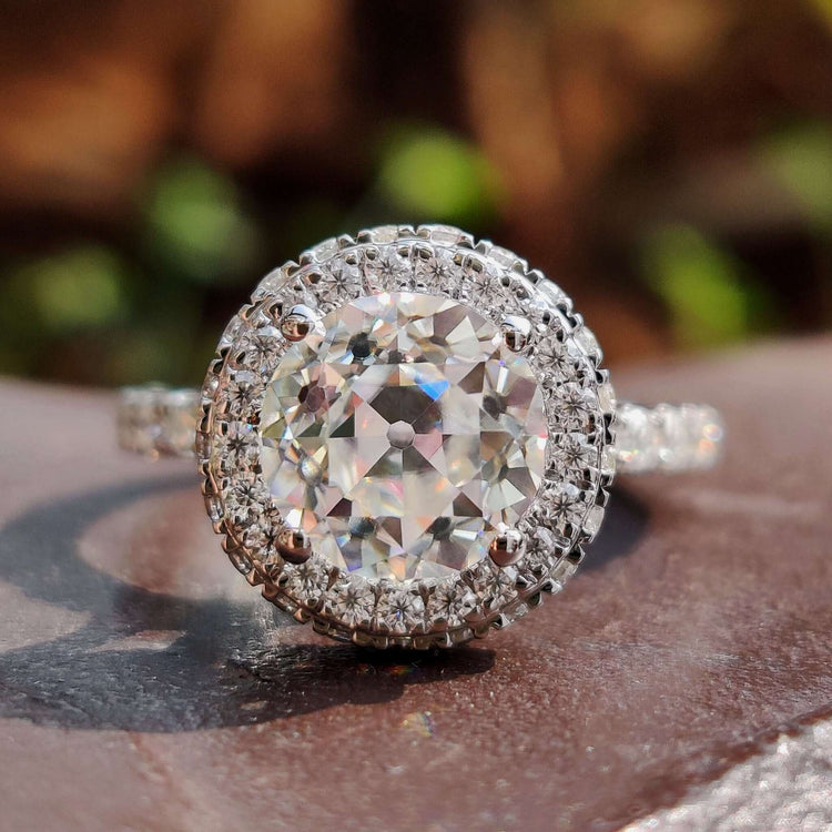 Round old European cut moissanite ring with hidden halo design.
