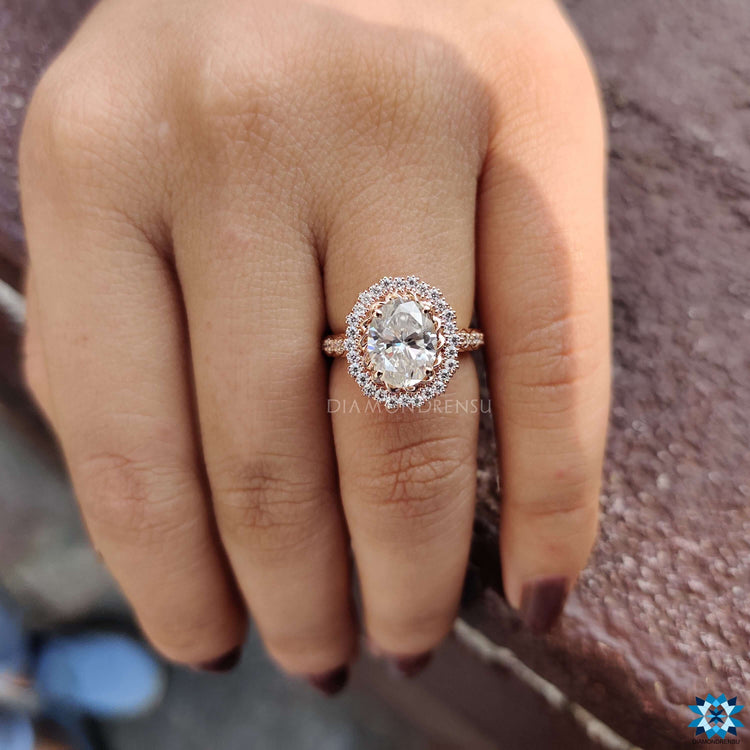 Halo ring in rose gold with pave engagement band.
