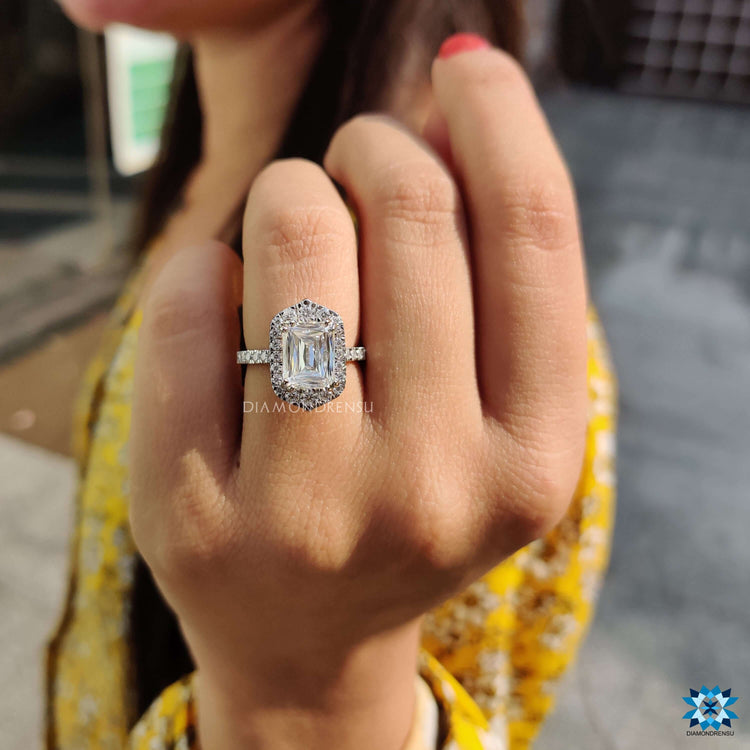 Blue center stone engagement ring with pave halo design.
