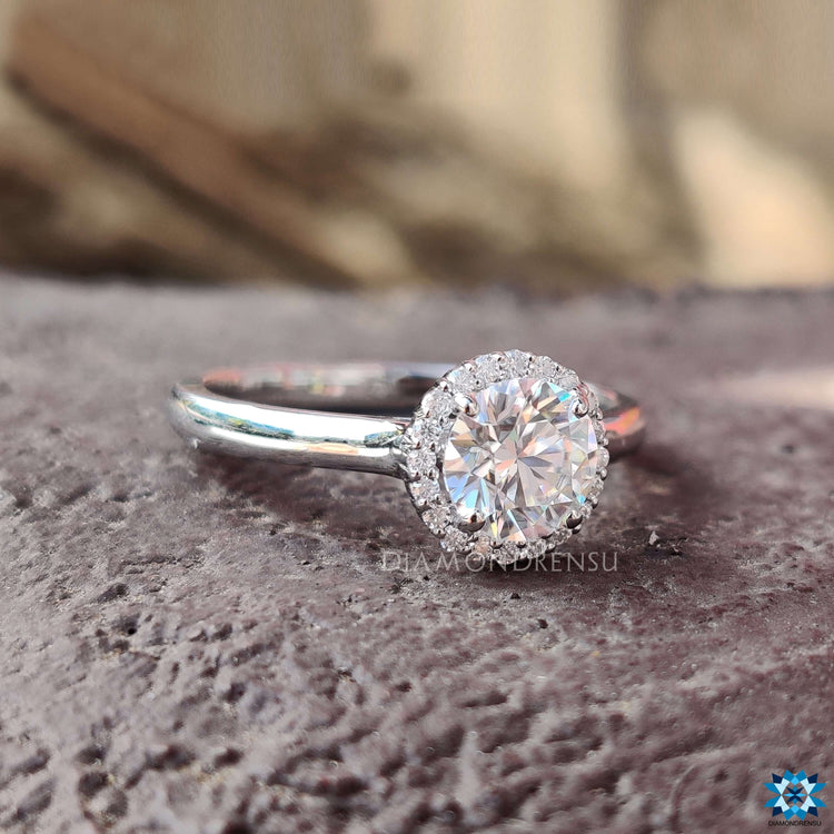 Halo engagement ring with cathedral setting and moissanite.
