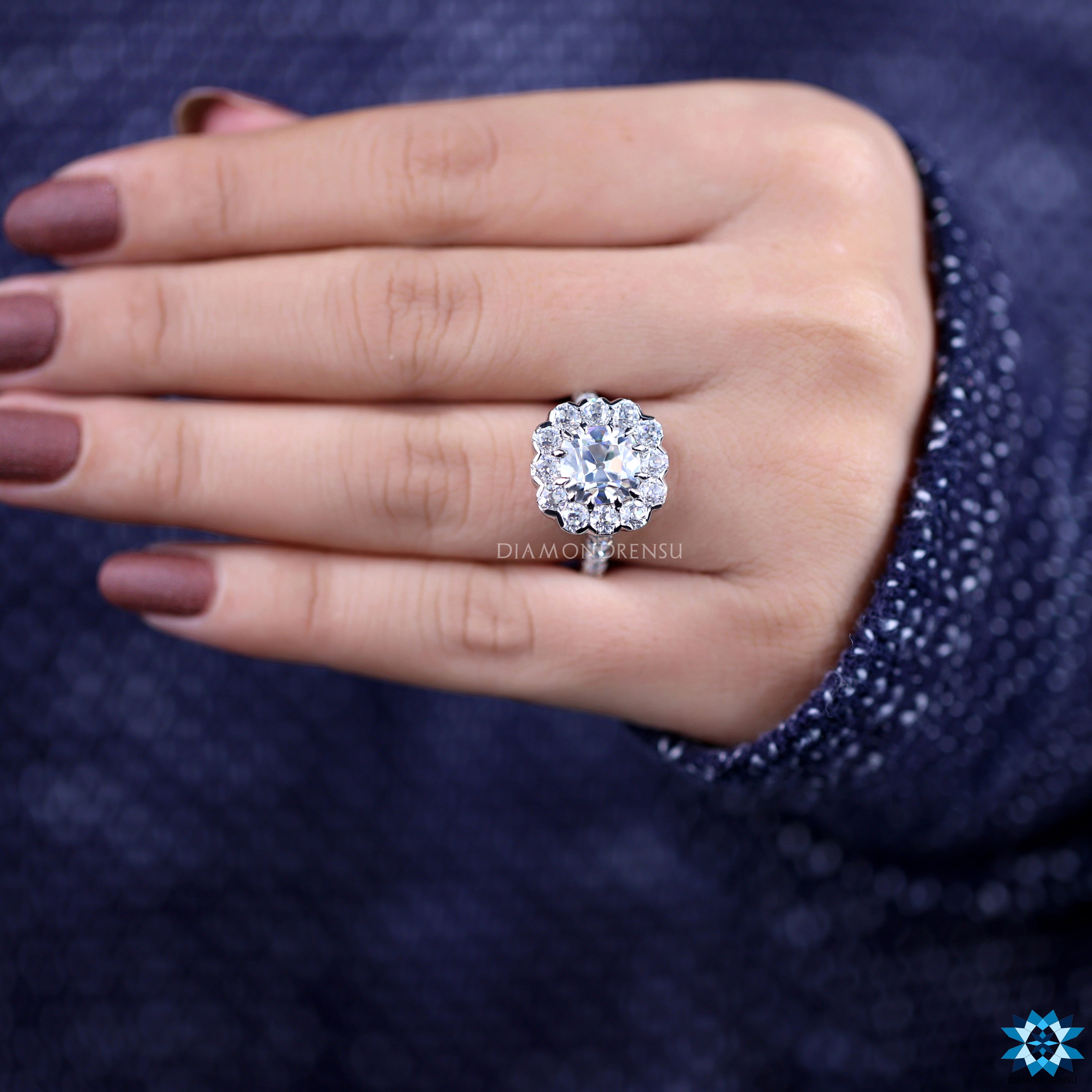 Round old European cut moissanite ring with white gold claw prongs.

