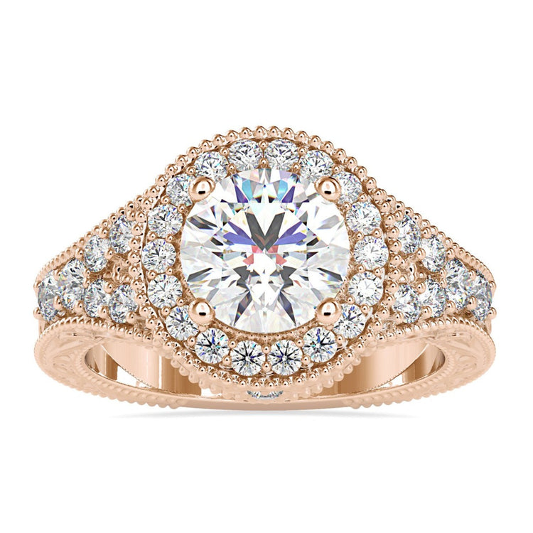 Split shank engagement ring with round cut halo setting.
