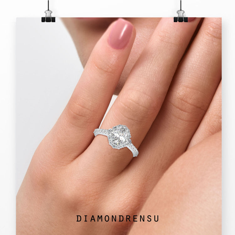 Cluster halo engagement ring featuring round side stones in white gold.
