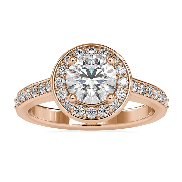 Round brilliant cut diamond engagement ring with halo setting in white gold.
