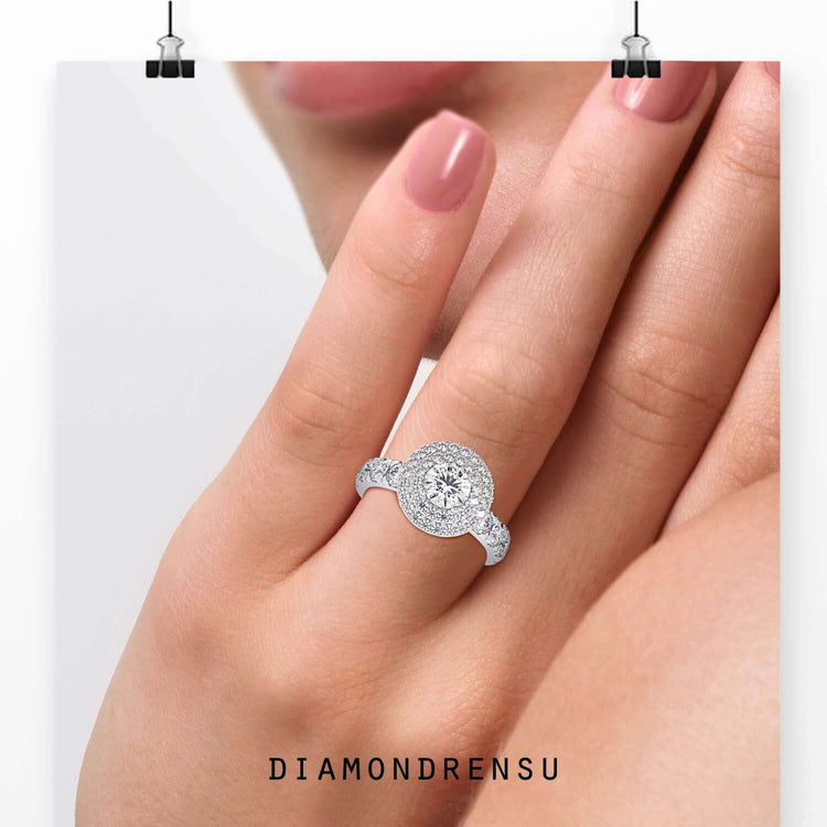 Round cut diamond centre with round side stones and double halo setting.
