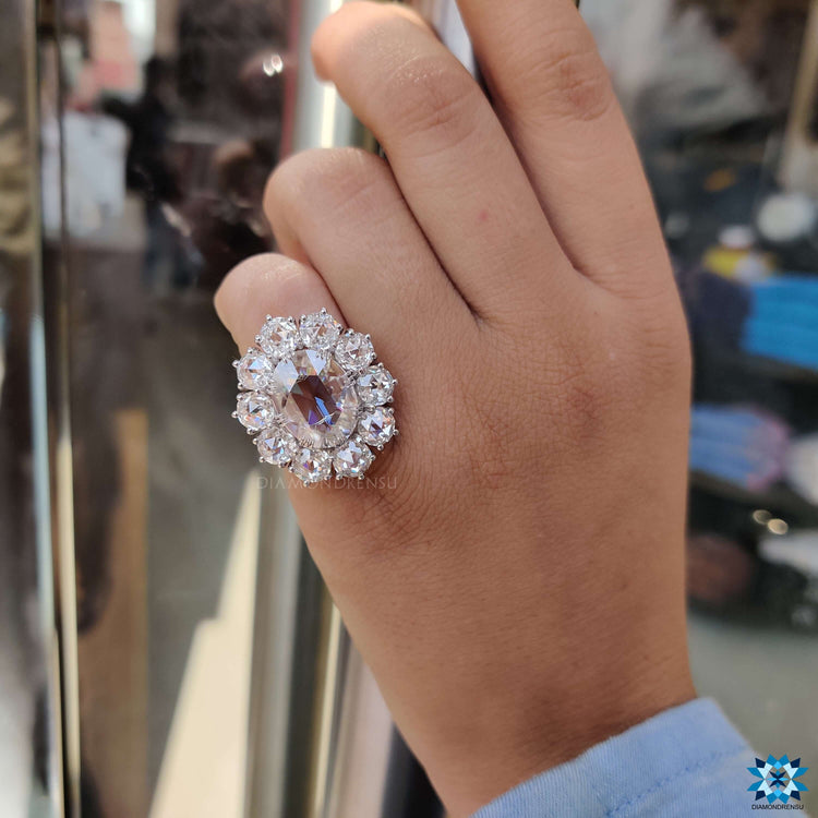 Fishtail prong setting holding rose cut moissanite in a cluster design.
