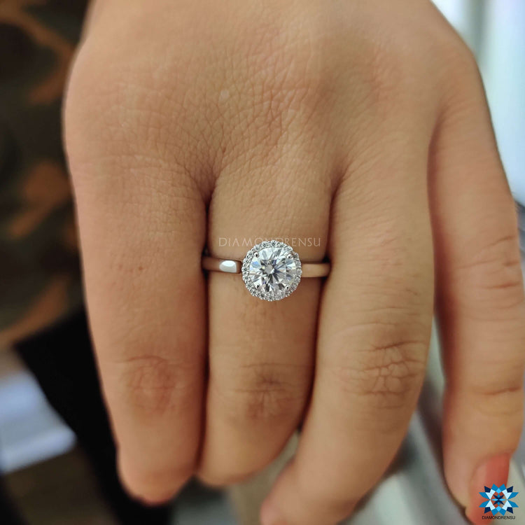 White gold engagement ring with moissanite halo.
