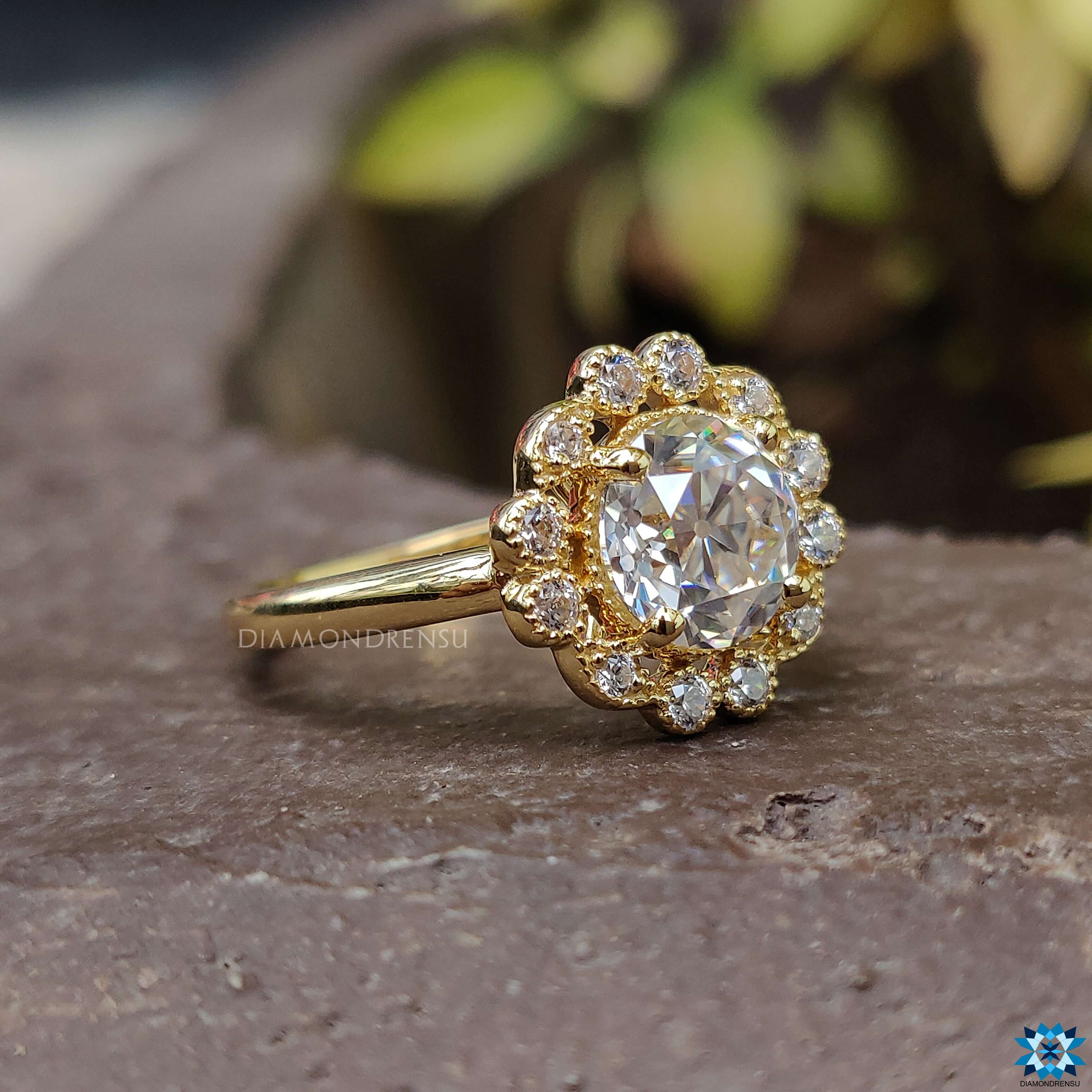 Floral style ring with a round brilliant cut moissanite centre stone.