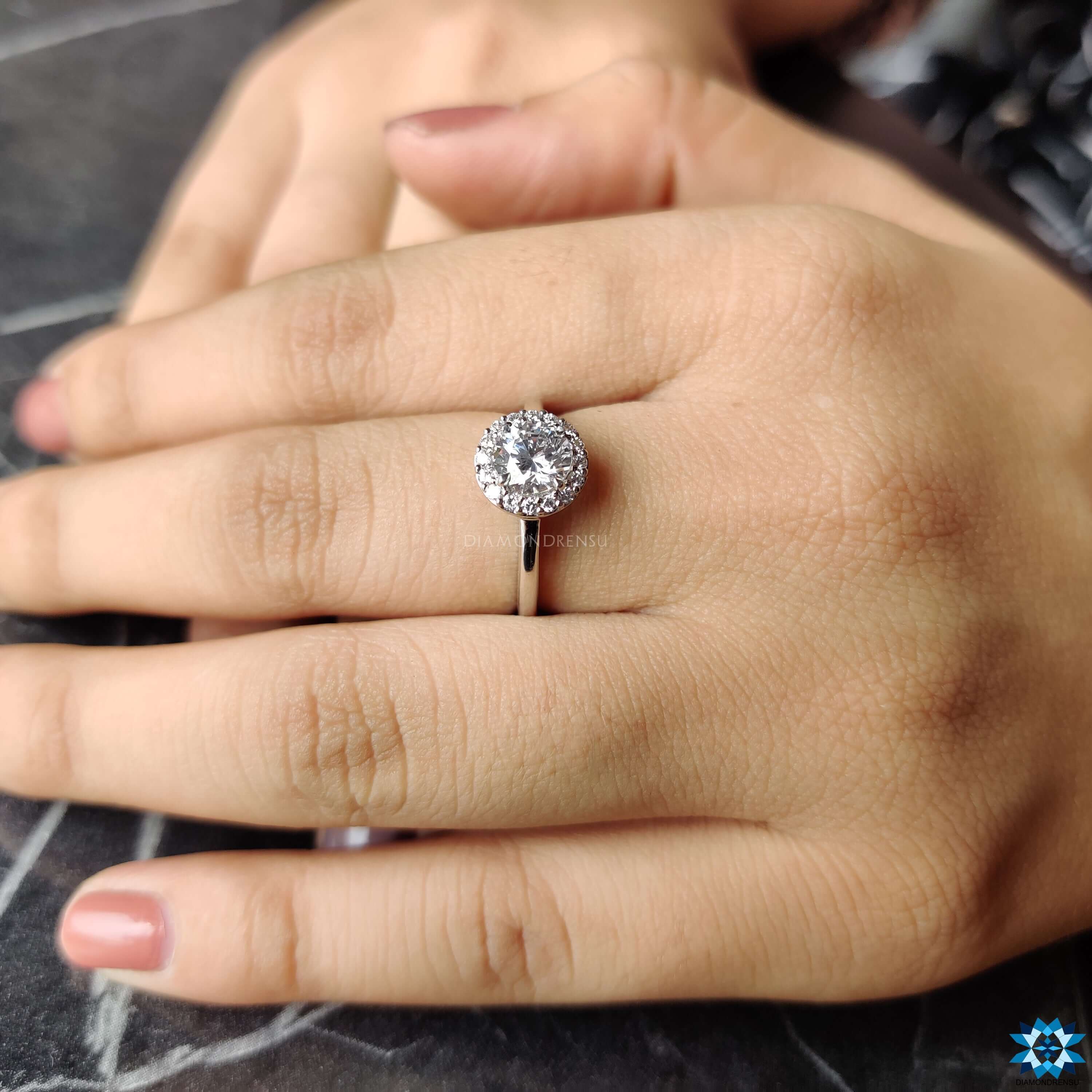 Round cut moissanite ring set in a beautiful halo engagement ring design.