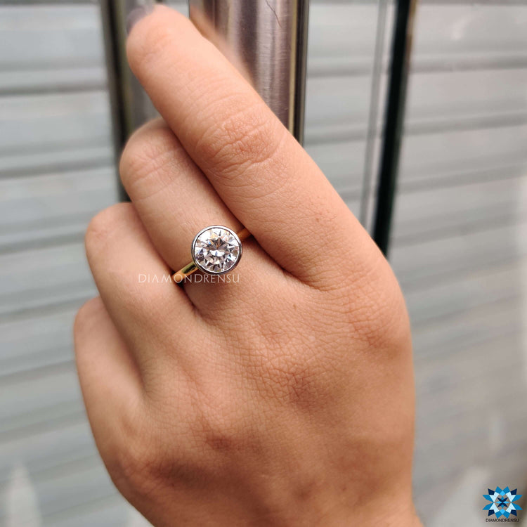 Moissanite ring with round cut stone and hidden halo.
