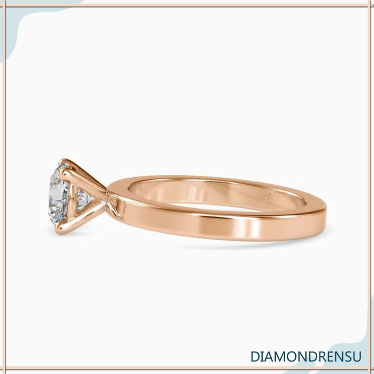 Rose gold engagement ring with round diamond, IGI certified.

