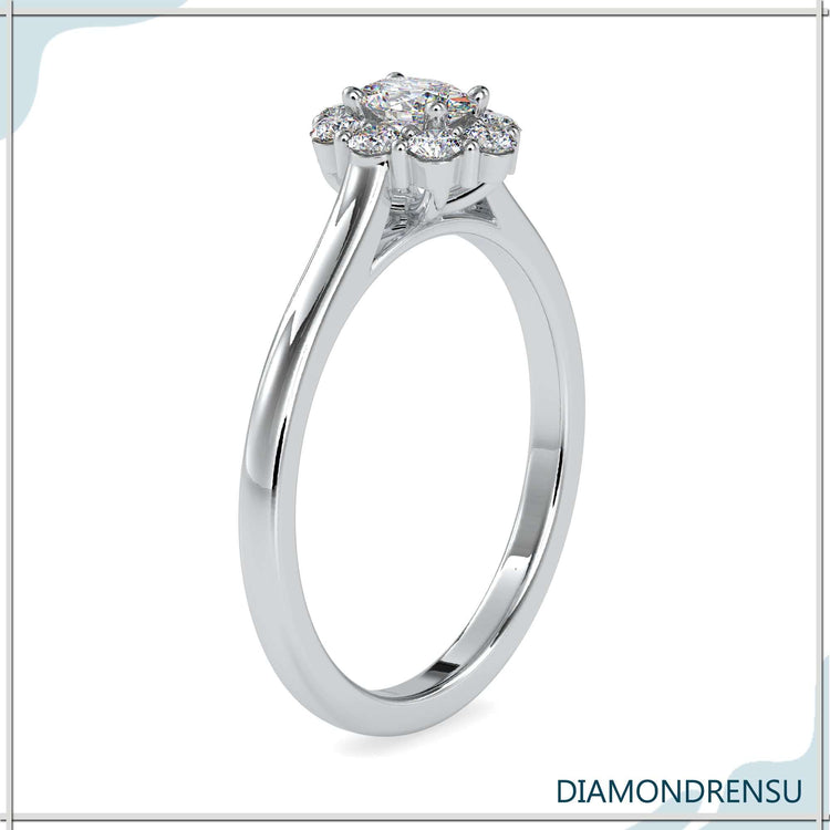 Lab diamond ring with oval cluster and 4 round prong setting.
