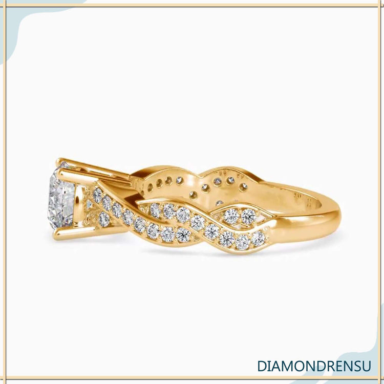 Yellow gold engagement ring with twisted design and round diamond.
