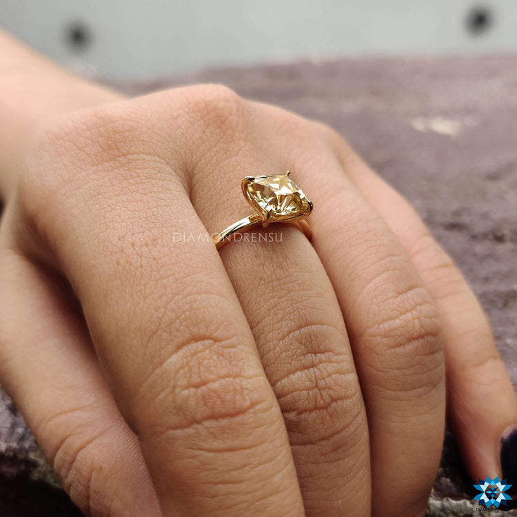 Classic solitaire moissanite ring in yellow gold.
