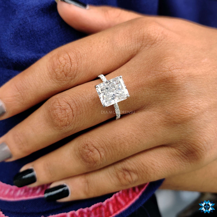 White gold ring with radiant cut moissanite center.
