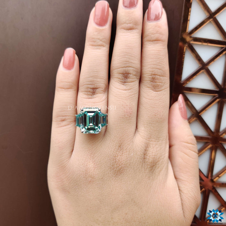 White gold three stone ring featuring unique side stones.
