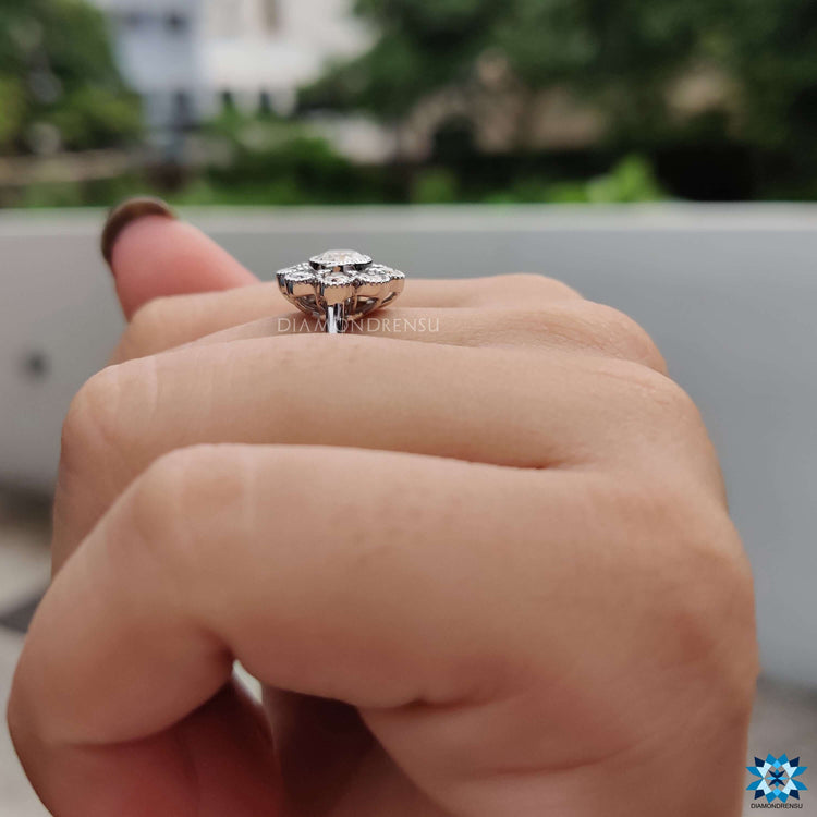 White gold flower style engagement ring with round brilliant cut accents.
