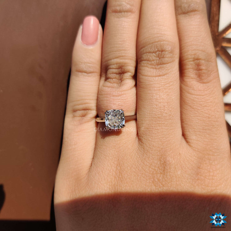Elegant white gold ring with Rensu cut cushion moissanite center.
