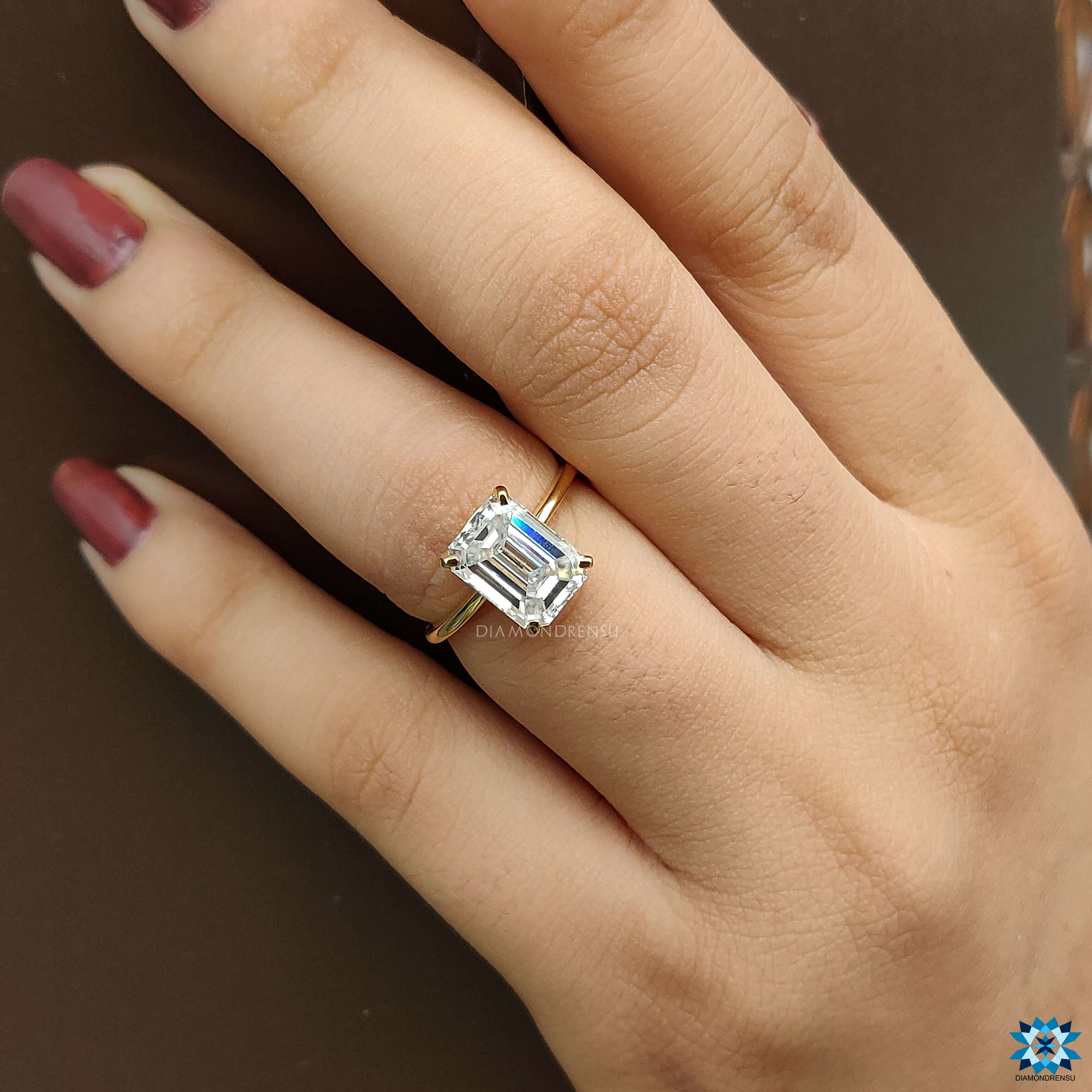 Beautiful moissanite solitaire engagement ring​ designed with an emerald cut for timeless elegance.
