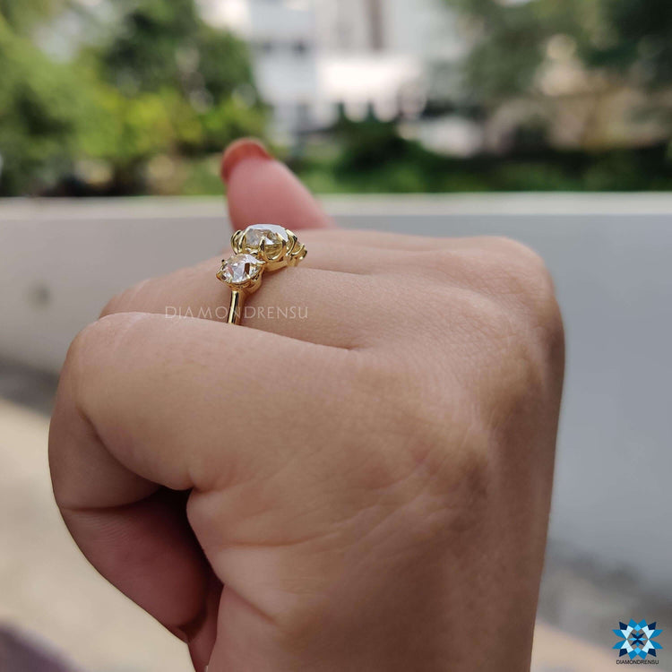 Vintage-style three stone ring in yellow gold with moissanites.
