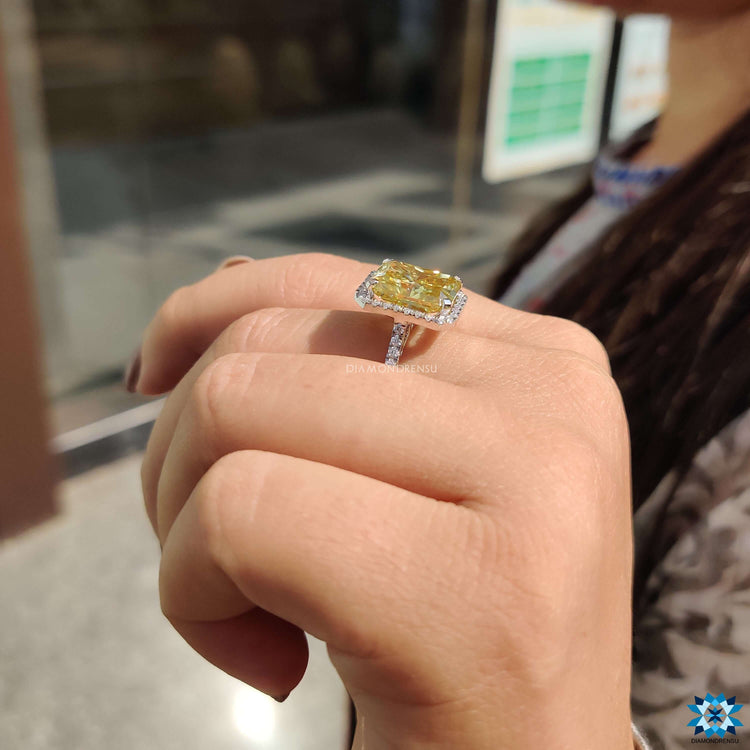 Radiant moissanite ring in white gold with pave accents.
