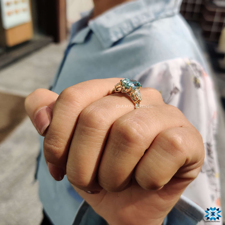 Custom engagement ring featuring a twisted band and pear cut sides.
