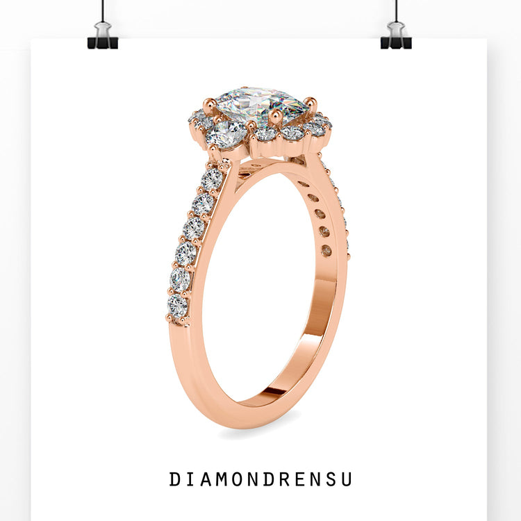 UK engagement ring in rose gold with oval and side diamonds.
