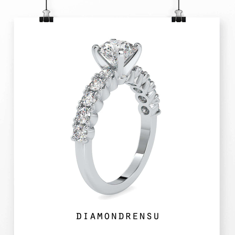 Designer ring with round centre diamond and tab prong setting.
