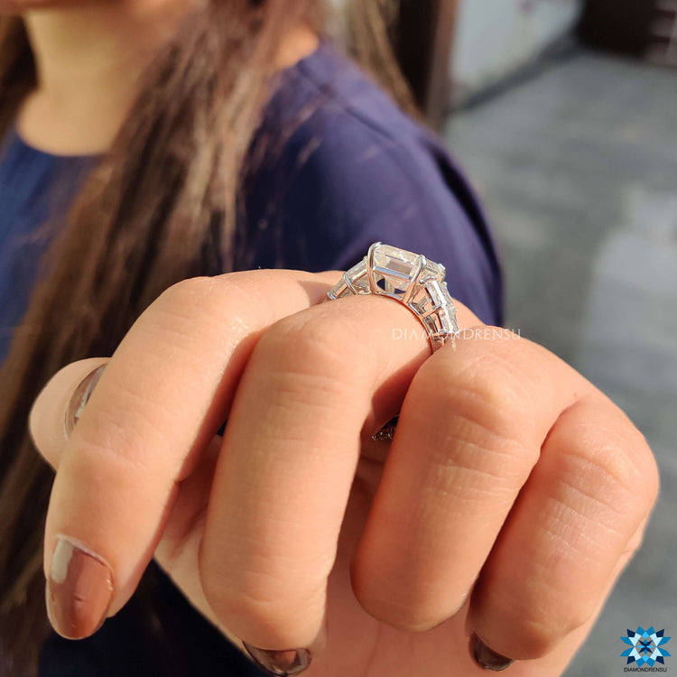 Moissanite pave engagement ring with emerald shaped center stone.
