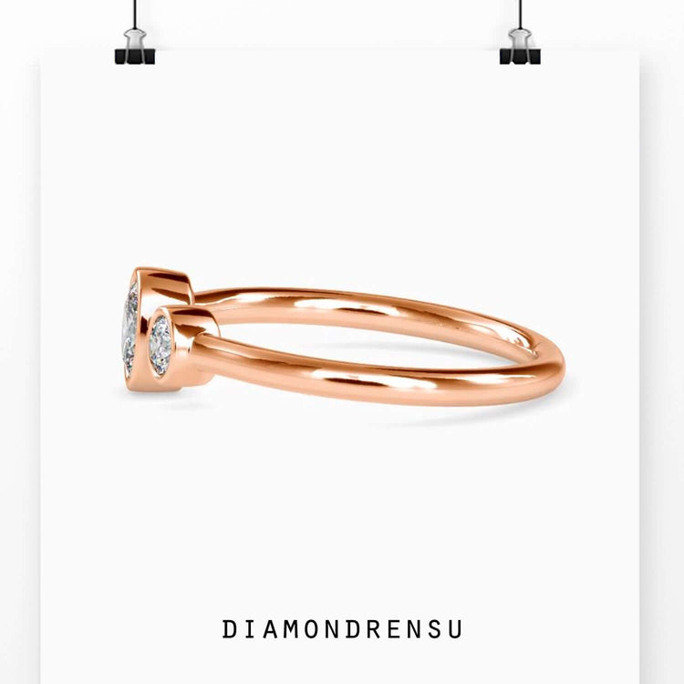 Lab grown diamond ring with oval centre and bezel side stones.
