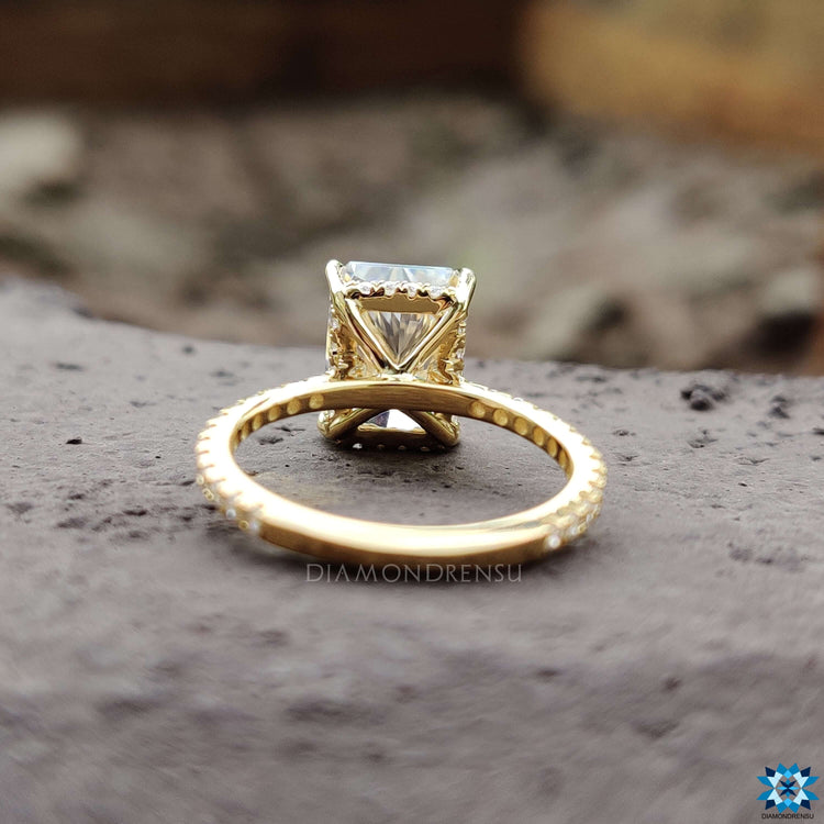Four claw prong moissanite ring with hidden halo.
