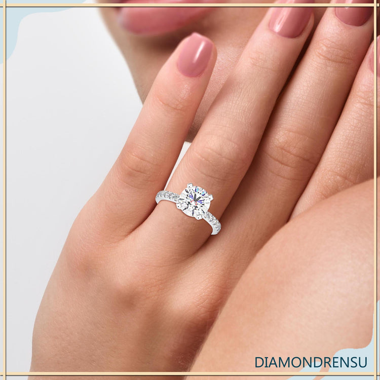 Round engagement ring with simple pave band.
