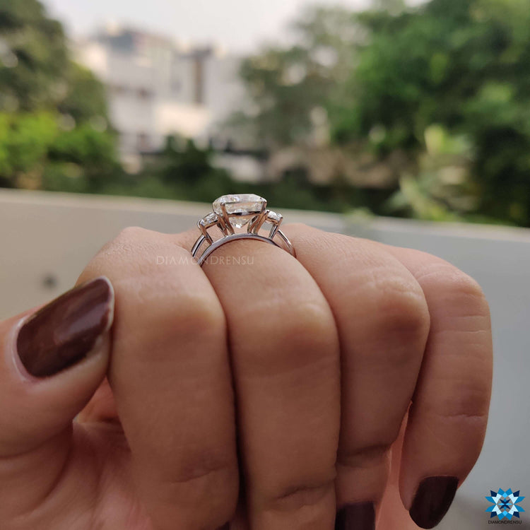 Custom cushion moissanite ring with half moon side stones.
