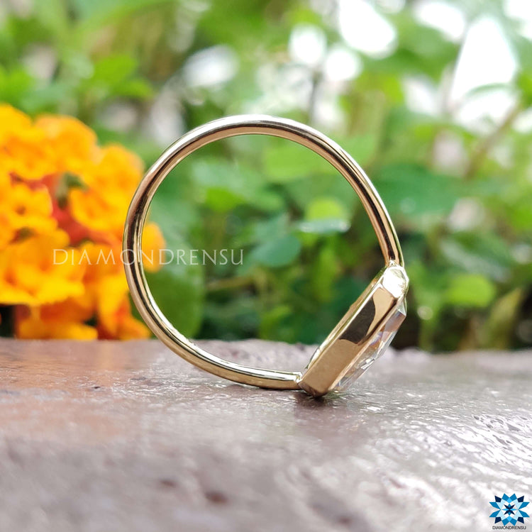 Handmade elongated cushion moissanite ring in yellow gold.
