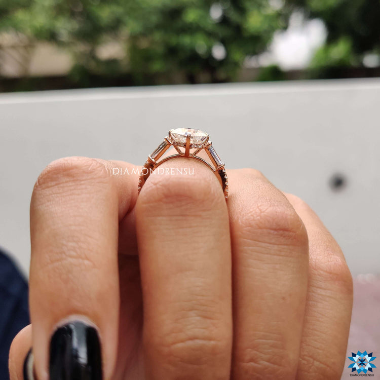 Elegant rose gold ring with moissanite and baguette side stones.
