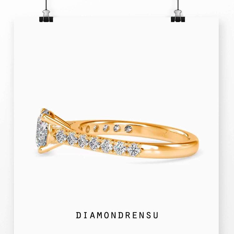 UK engagement ring with round brilliant cut and custom pave band.

