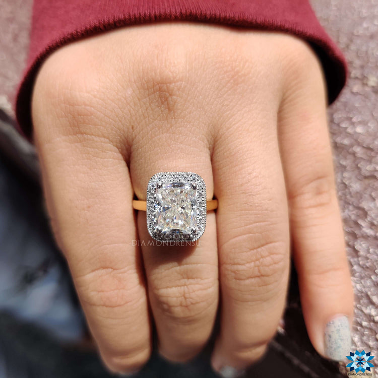 Halo setting moissanite ring with radiant center stone.
