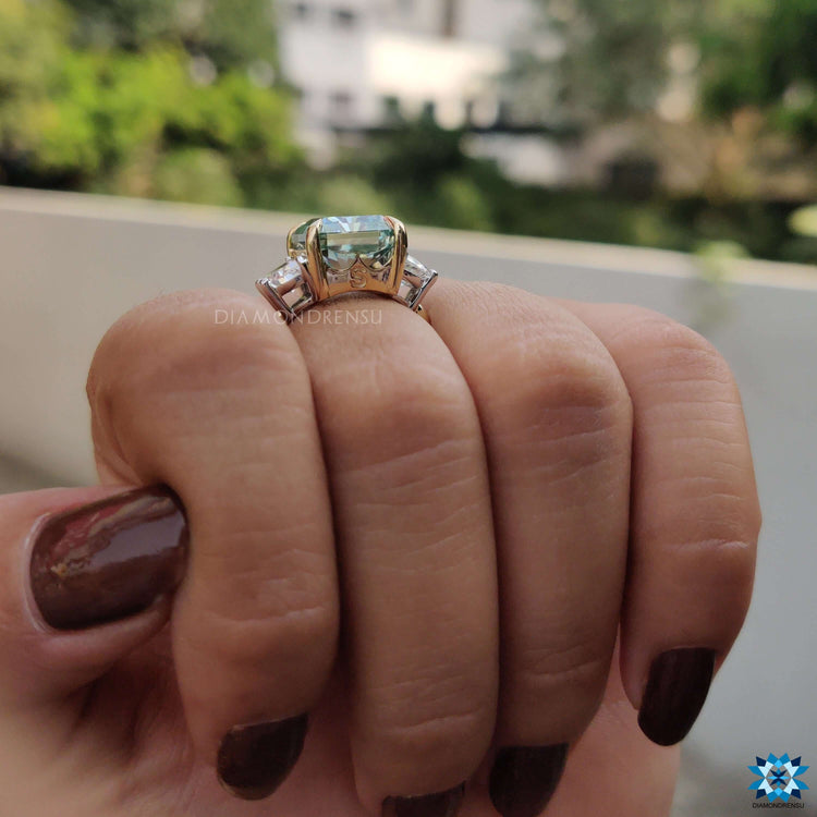 Engagement ring featuring radiant cut center and curved sides.
