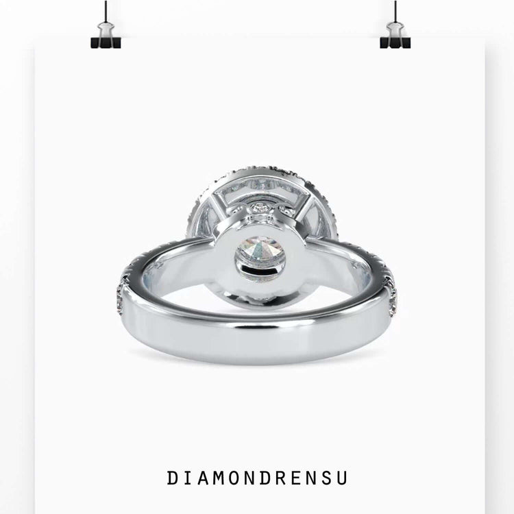 Lab diamond ring with round cut centre and halo of round accents.
