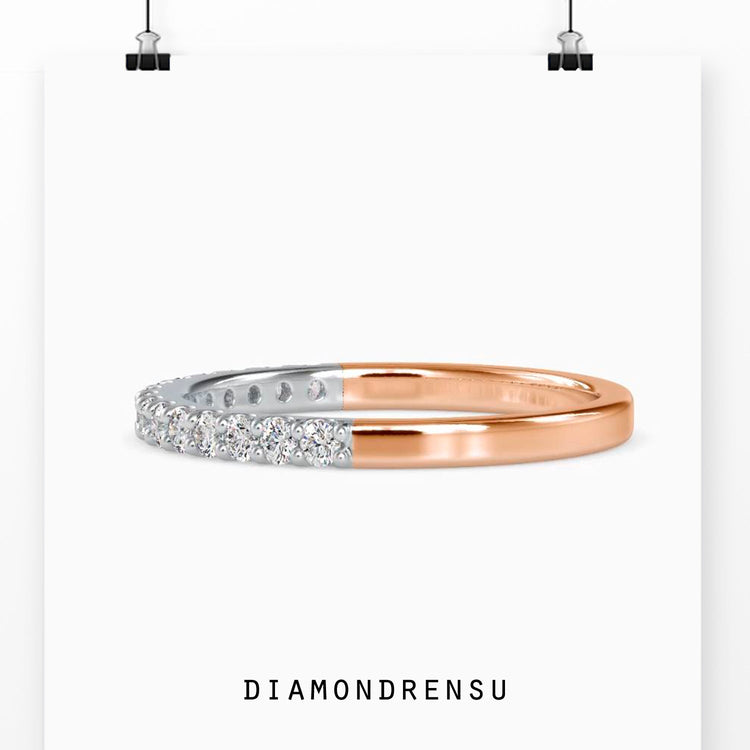 Prong setting band crafted in rose gold with diamonds.
