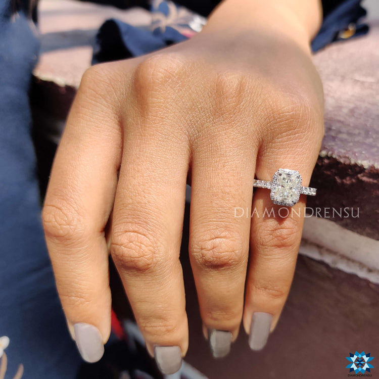 Moissanite halo engagement ring in prong and pave setting.
