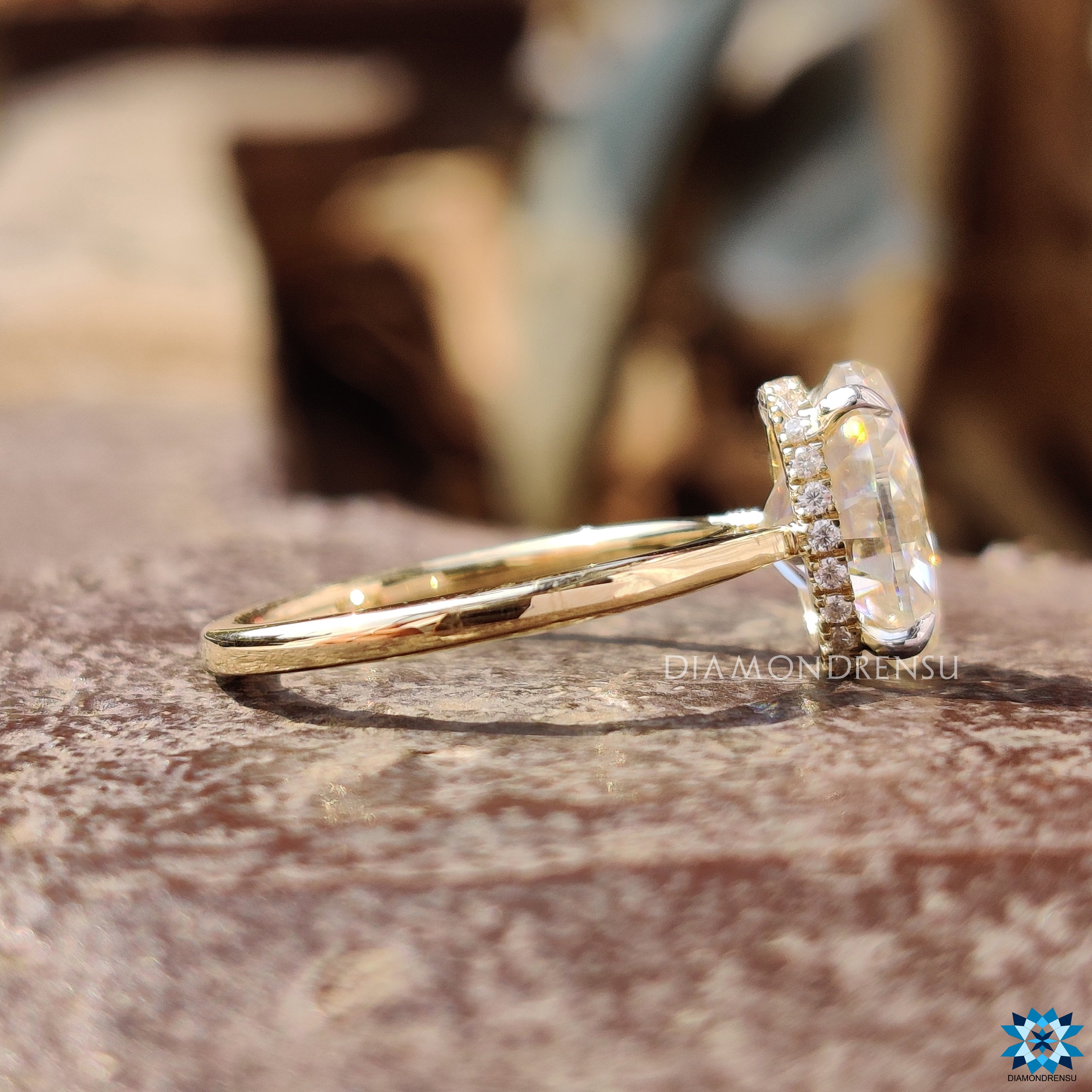 Handmade jewellery showcasing oval moissanite and elegant halo detailing.
