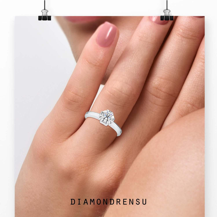 Handmade solitaire engagement ring featuring a peekaboo diamond.
