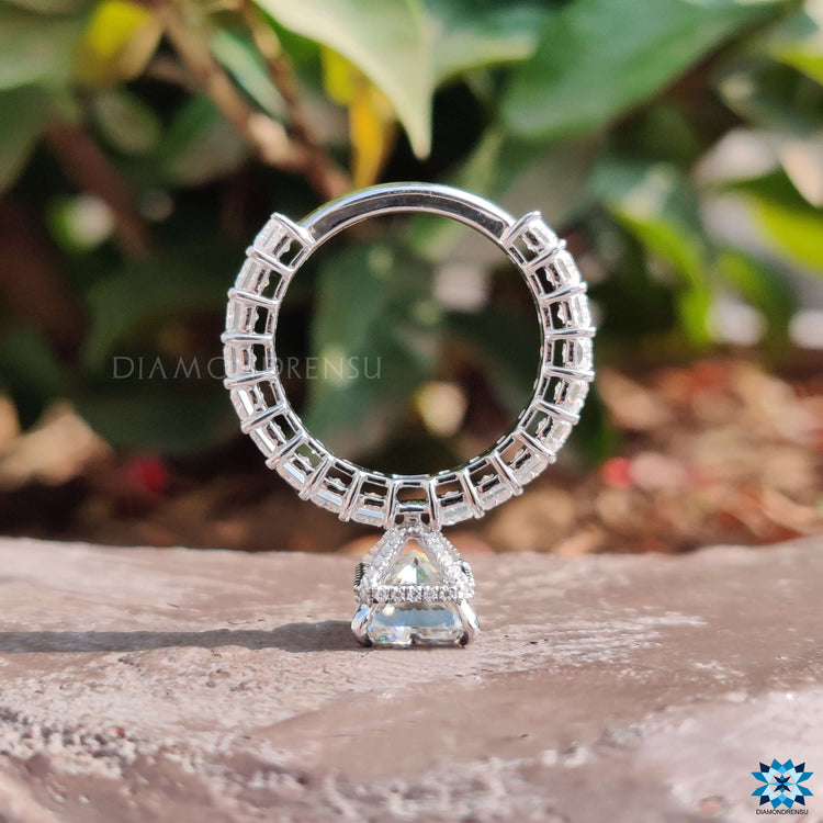 Moissanite pave ring with radiant cut center stone.
