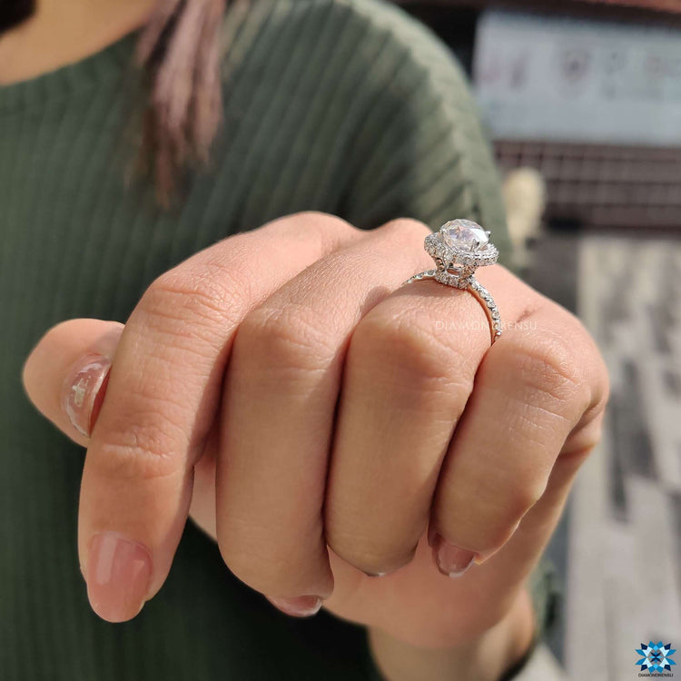 Prong set round moissanite ring in hidden halo style.
