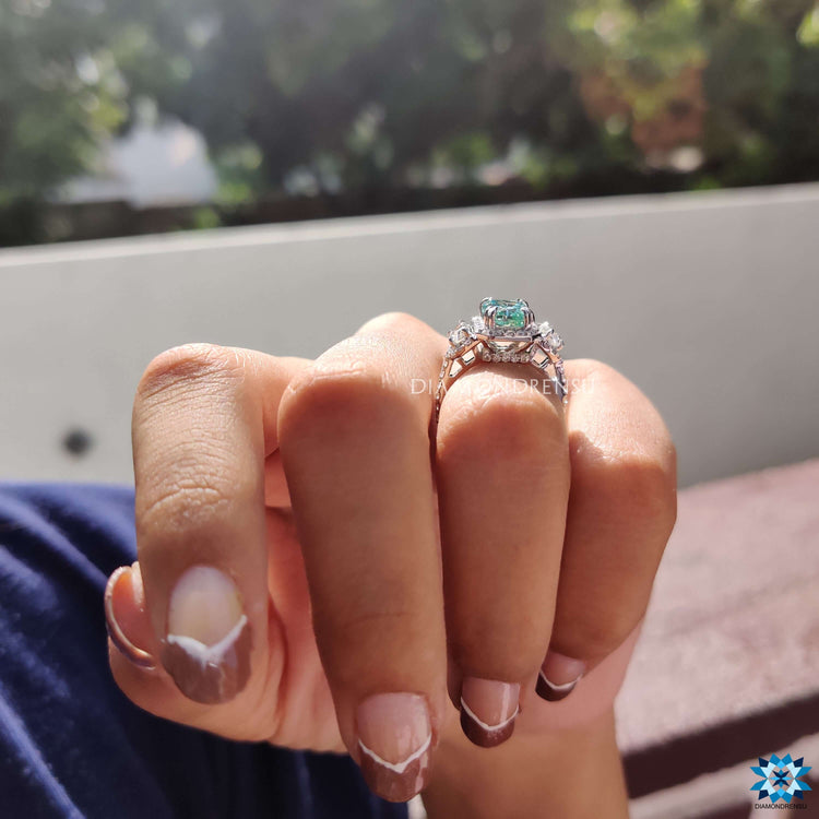 White gold engagement ring with radiant blue moissanite.
