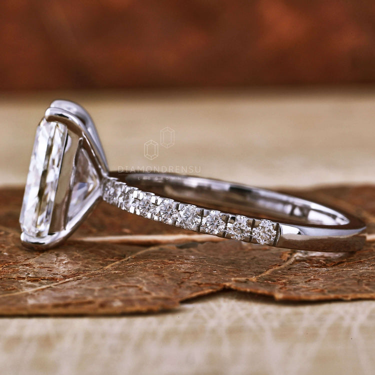 Radiant engagement ring showcasing a radiant cut diamond and a delicate pave setting for added brilliance.

